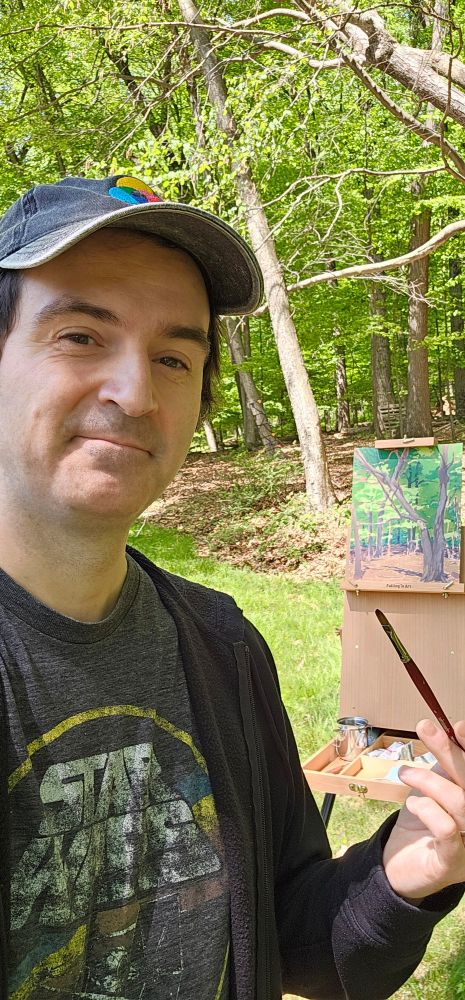 The artist posing with his easel.