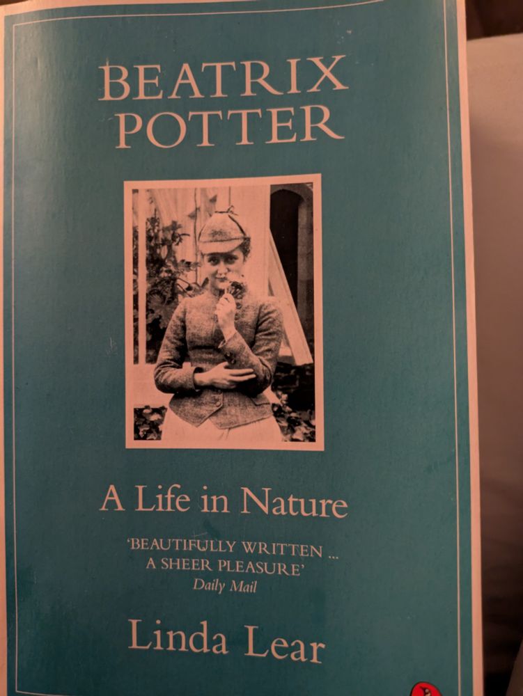 The front cover of Beatrix Potter A Life in Nature by Linda Lear with a black and white photo of Beatrix in the centre.