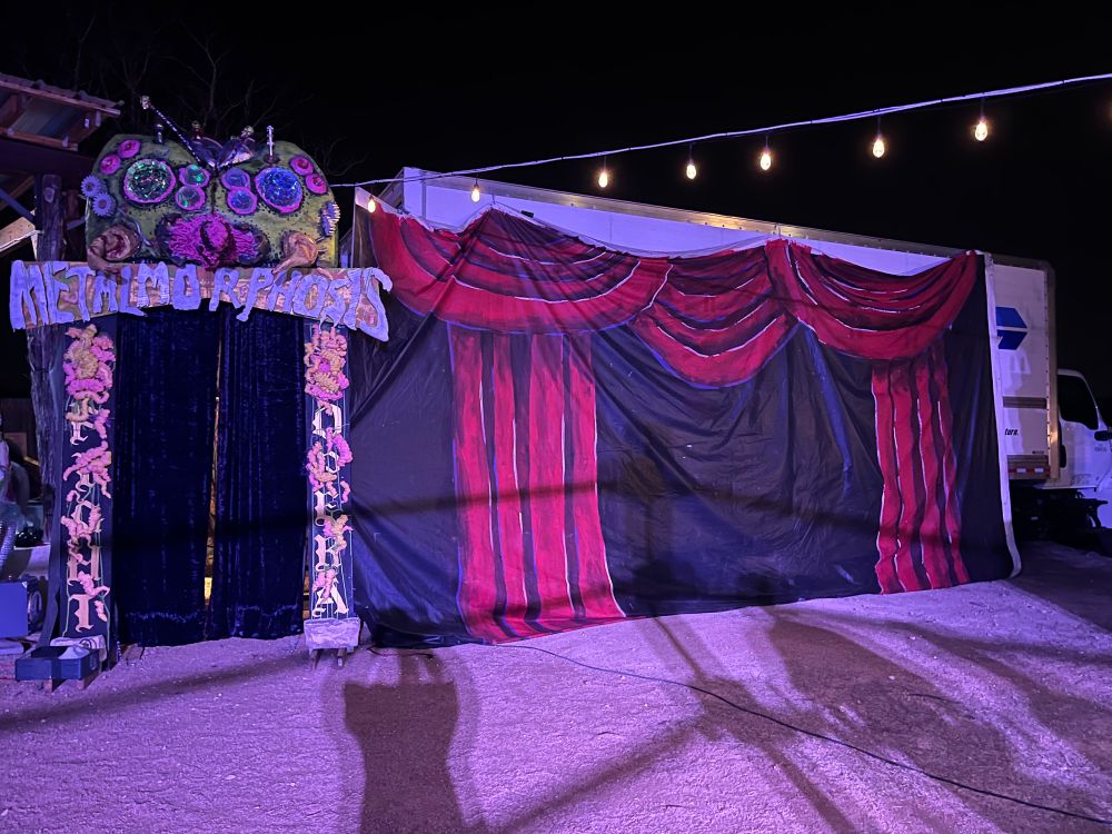 The entrance arch and painted red curtain vinyl truck cover for Fight Opera’s METALMORPHOSIS. The entrance arch is a big bug with many eyes