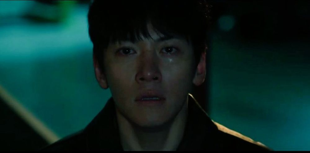 South Korean Actor Ji Changwook in "The manipulated" he is staring at camera with a tearful expression. He has short dark hair and his mouth is slightly open. He's wearing a leather jacket.