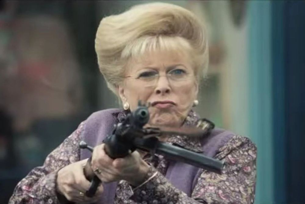 Billie Whitelaw firing a machine gun.