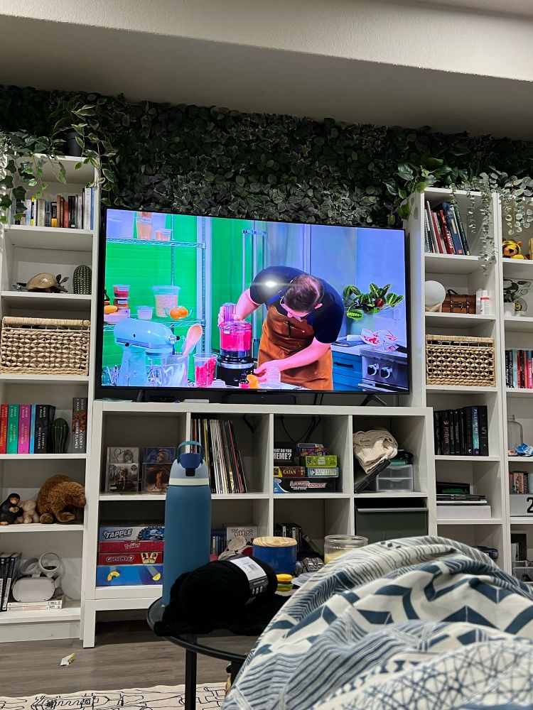 Bookshelves and TV, try guys “without a recipe” is playing