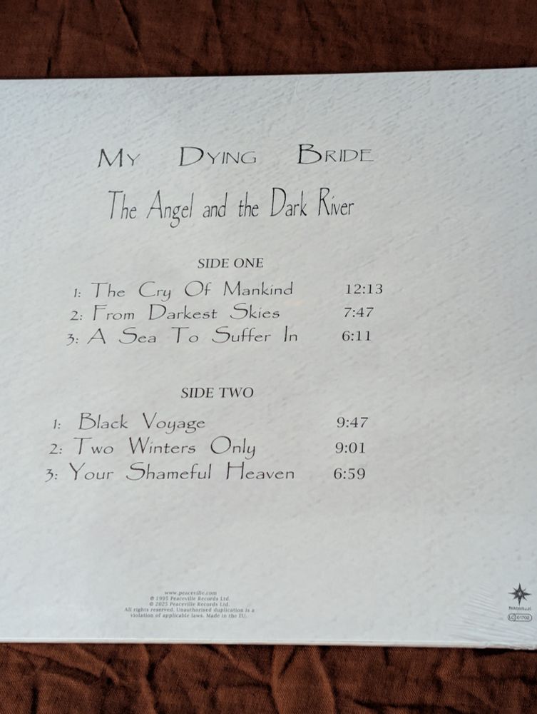 The back of the album. At the top is the text of the band's name, "My Dying Bride". The line below is the album name, "The Angel and the Dark River" and below that is the track listing: 

Side One
1.	"The Cry of Mankind"	       12:13
2.	"From Darkest Skies"	       7:47
3.	"A Sea to Suffer In"    	       6:11

Side Two
4.	"Black Voyage"	                9:47
5.	"Two Winters Only"	          9:01
6.	"Your Shameful Heaven"	6:59

Originally released by Peaceville Records in 1995
Re-released by Peaceville Records in 2025

Aaron Stainthorpe - vocals, cover art, photos
Andrew Craighan - guitar
Calvin Robertshaw - guitar
Adrian Jackson - bass
Martin Powell - violin, keyboard
Rick Miah - drums