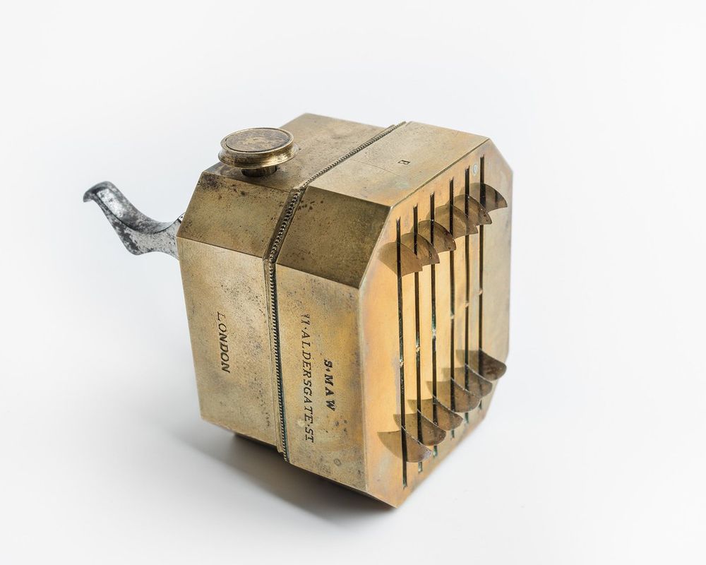 A square, brass instrument with multiple blades. 