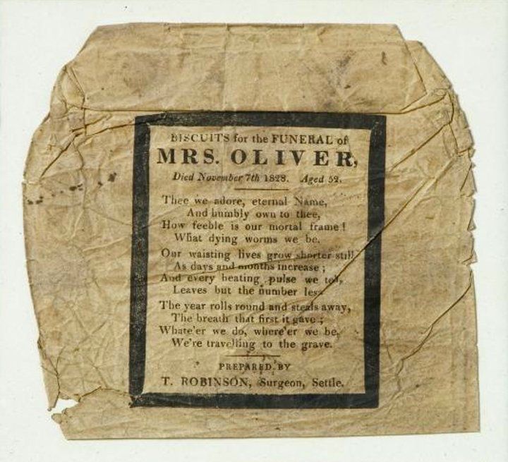 A wrapper that has yellowed with age. On it is text that reads: "Biscuits for the funeral of Mrs. Oliver. Died November 7th, 1828. Aged 52." Along with a prayer. 