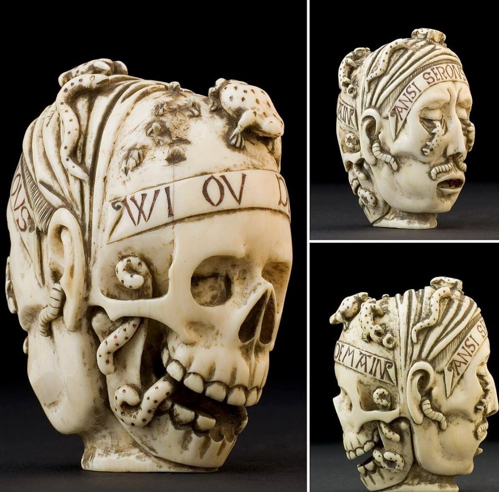 A small ivory skull. One side shows the skeleton. The other shows the fleshy face with worms coming out of it. 