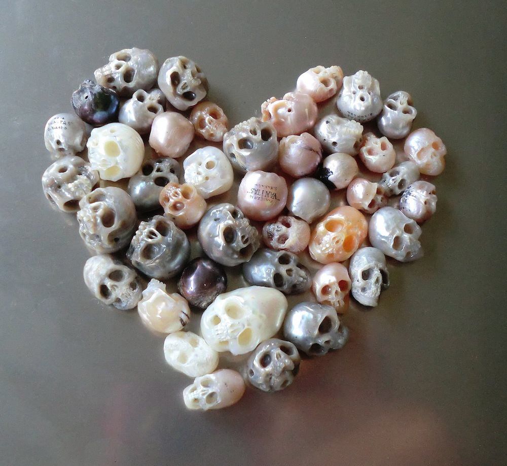 Tiny little pearl skulls arranged in a pattern that resembles a heart. 
