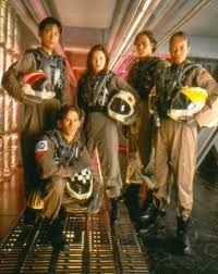 The younger cast of Space: Above and Beyond, in their battle gear. They are holding helmets