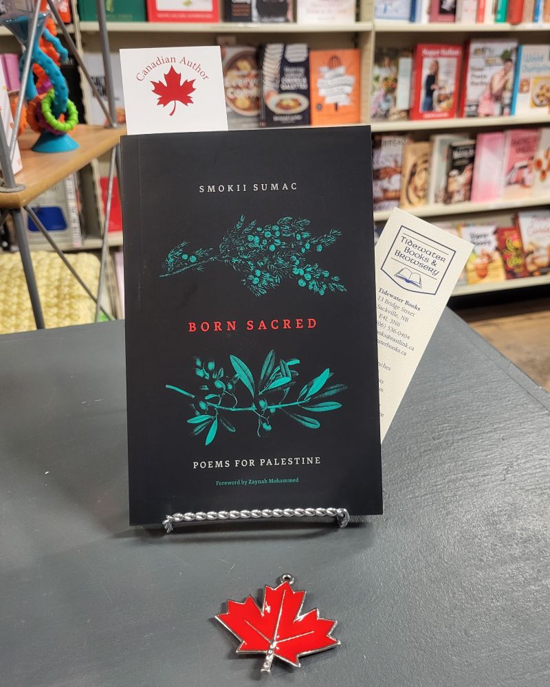 book on counter: 'Born Sacred: Poems for Palestine' by Smokii Sumac & Zaynab Mohammed, Tidewater books bookmark, Canadian Maple Leaf symbol