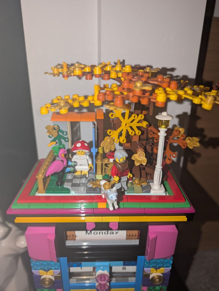 Lego autumn scene with tree, mushroom child, dog and dog walker. Flamingo lawn ornament 