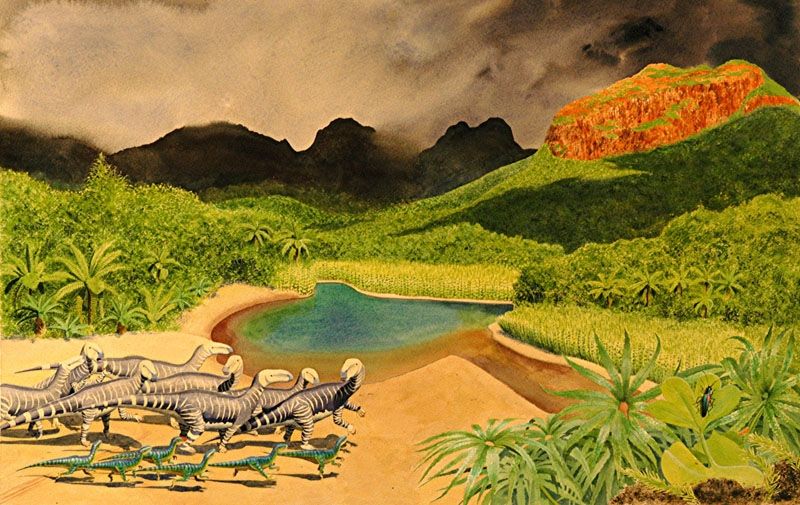 Group of stripey theropods on a sandy shoreline look beyond a placid, turquoise pond toward a red and angry volcano. Billowing grey haze above their luscious forest blots out the sky.