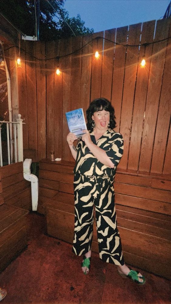 me making an insane exuberant face while holding my book