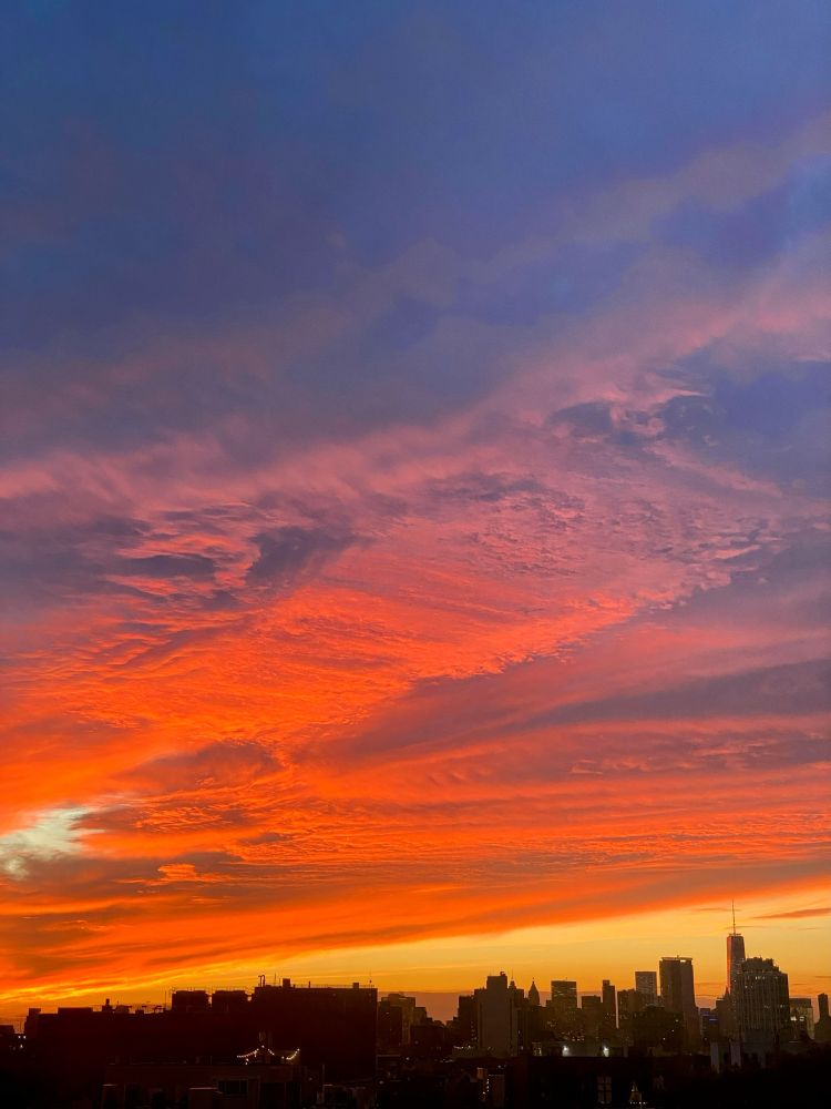 lotta colors and textured clouds over the Manhattan skyline