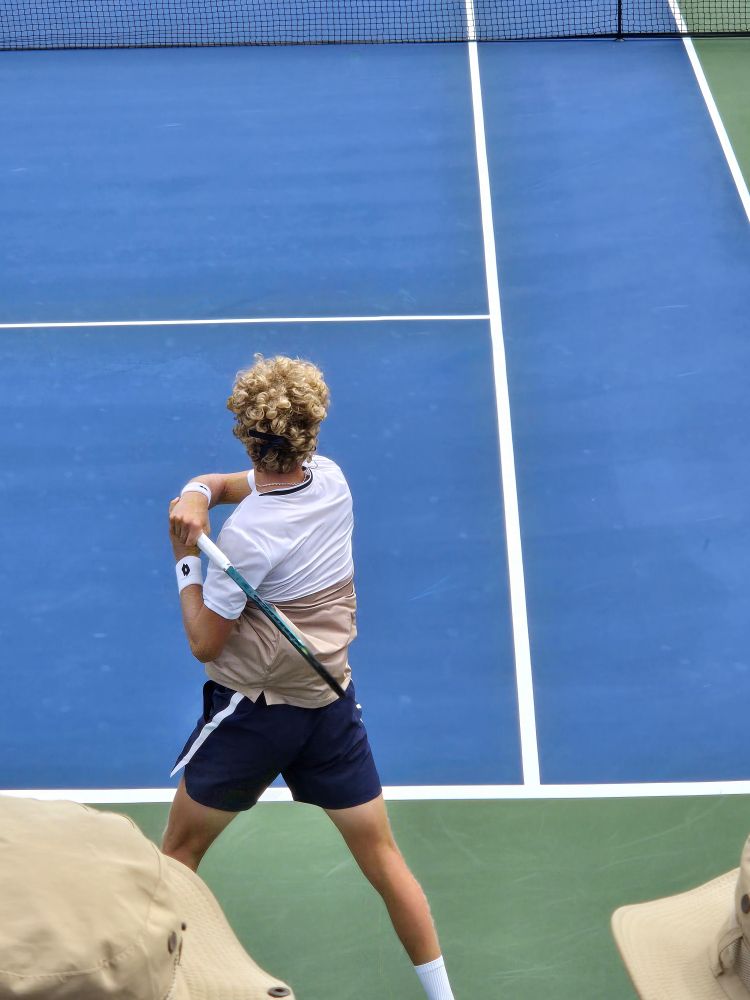 Martin Landaluce with his wild hair returns a ball.