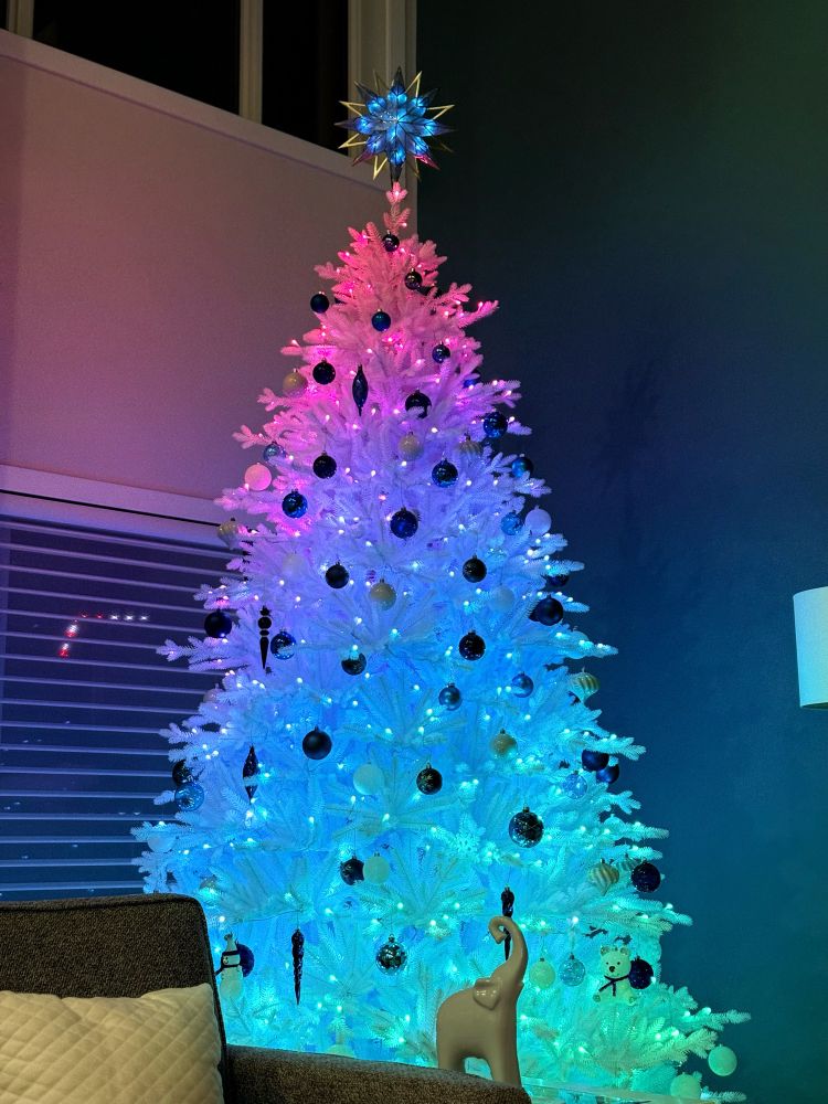 A white Christmas tree with colorful lights 