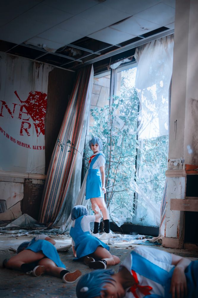 A cosplay of Rei Ayanami from Neone Genesis Evangelion, standing in an abandoned building with copies dog herself crawling towards her