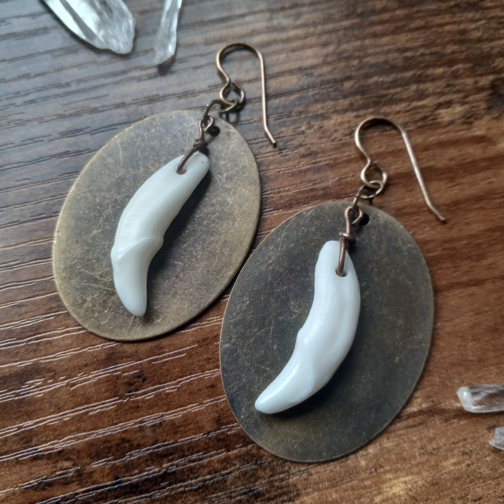 Ethically sourced coyote canine teeth on antiqued brass hardware.