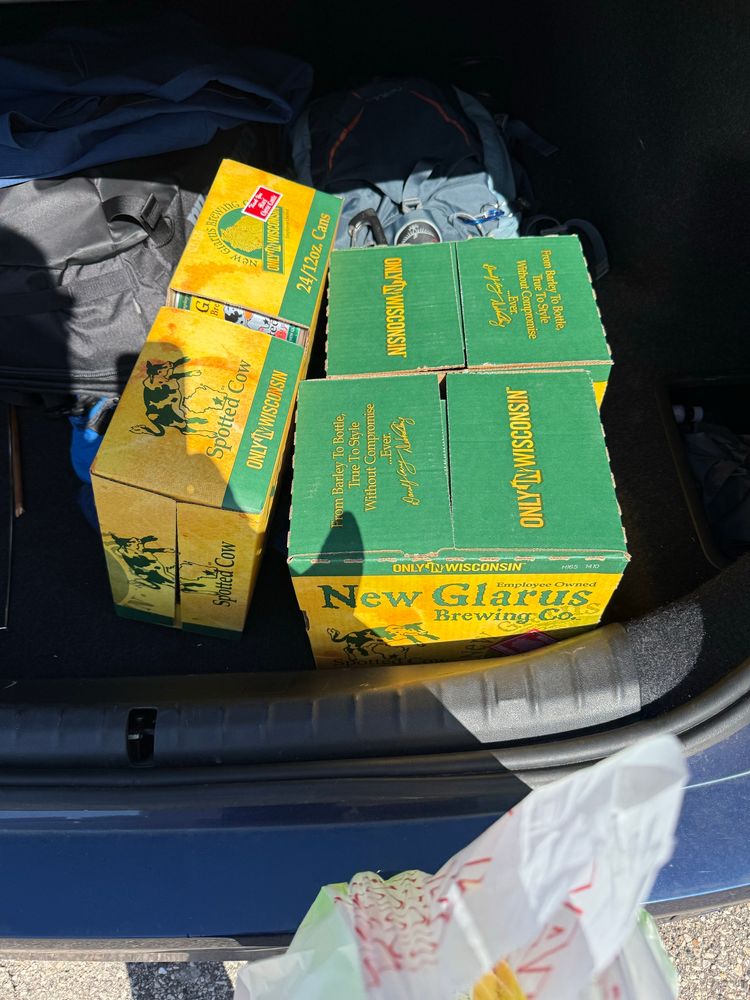 3 cases of spotted cow beer from New Glarus brewing in Wisconsin in the trunk of a car. 