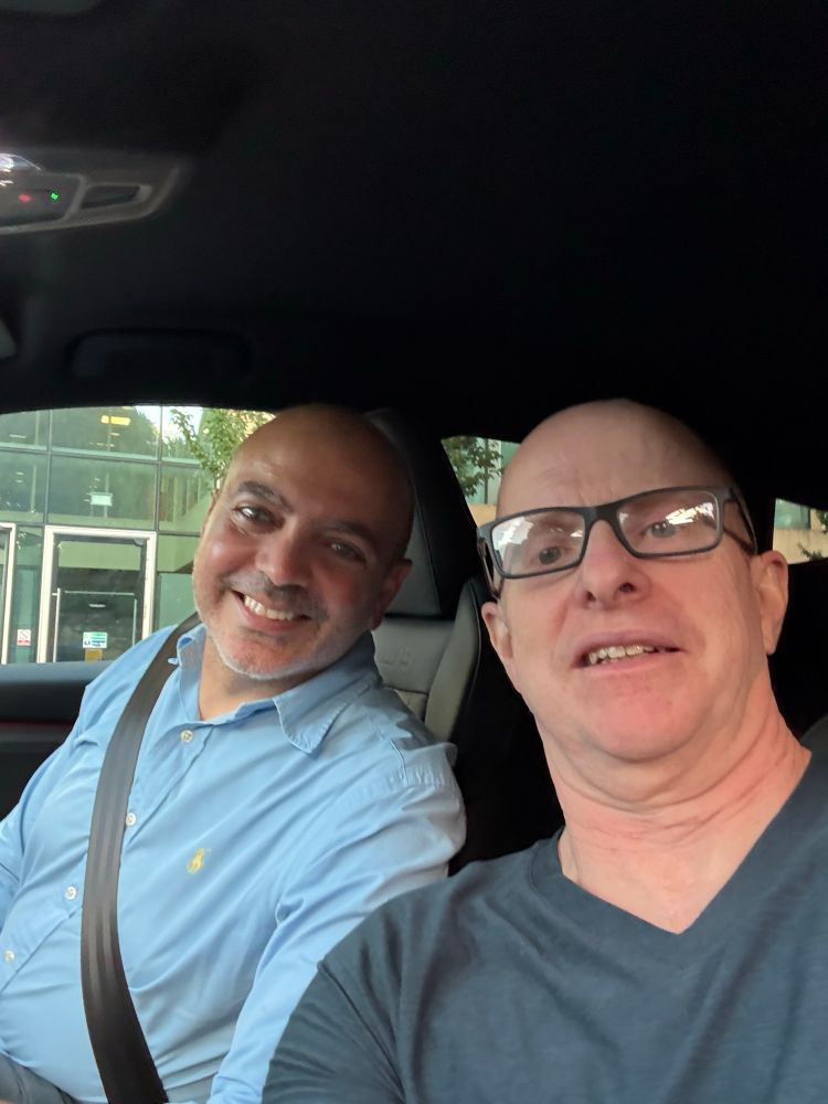 Old bald white guy with young bald Cypriot 