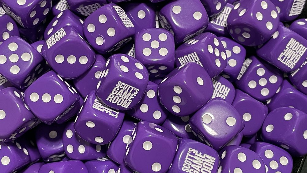 A bunch of purple six-sided dice with "Scott's Game Room" as the six face
