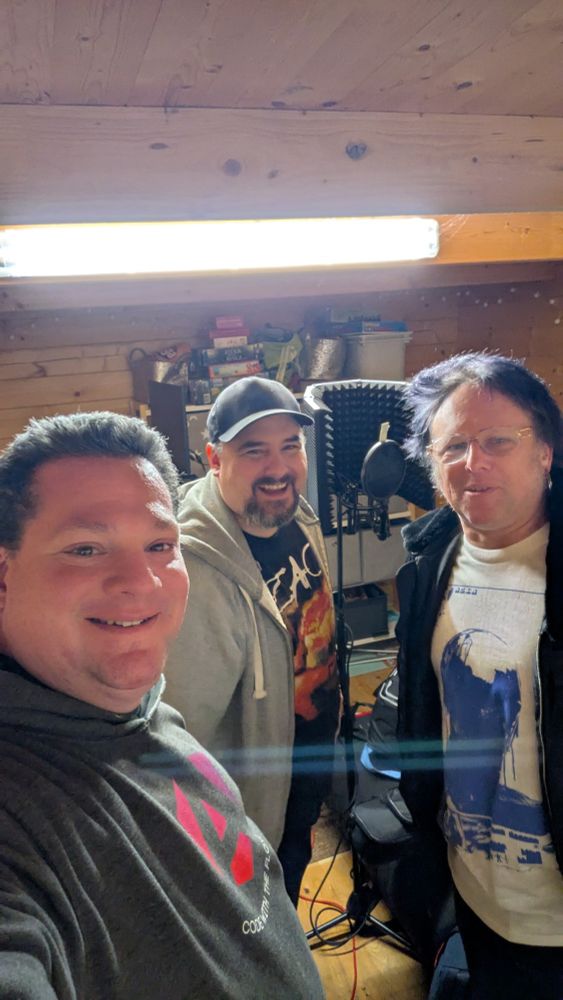 All band members are smiling into the camera.