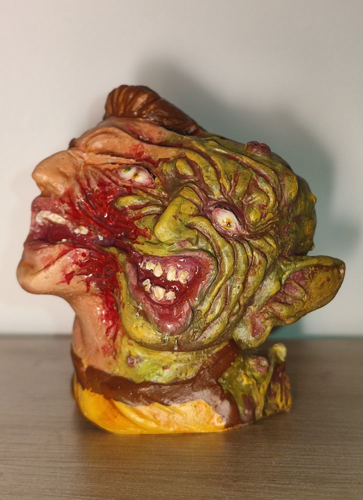 Painted handmade resin figure of Ricky coogin from the movie Freaked 1993, his face is half human half green monster. The two sides of the face are tearing apart from each other
