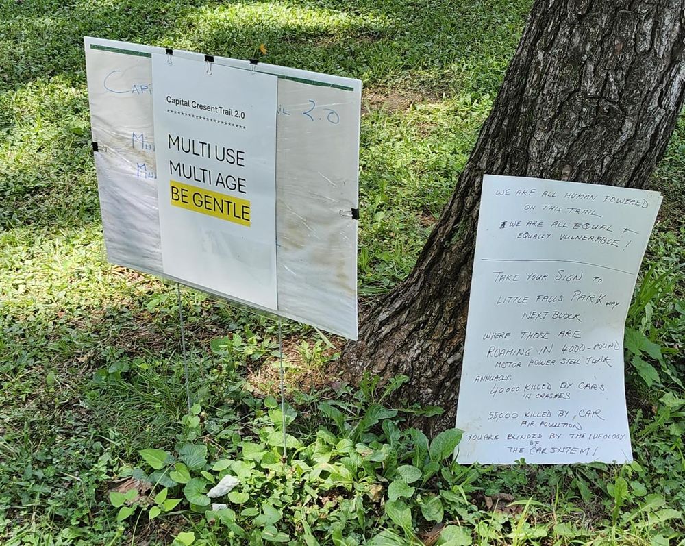 Left: Capital Crescent Trail 2.0. Multi-use. Multi-age. Be gentle.
Right: We are all human powered on this trail. We are all equal & equally vulnerable. Take your sign to Little Falls Parkway next block where those are roaming in 4000-pound steel junk. Annually 40,000 killed by cars in crashes, 55,000 killed by car air pollution. You are blinded by the ideology of the car system!