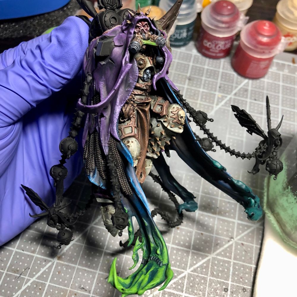 Mort getting their cloak on with a purple and blue combo. The bottoms are turning into a green miasma 