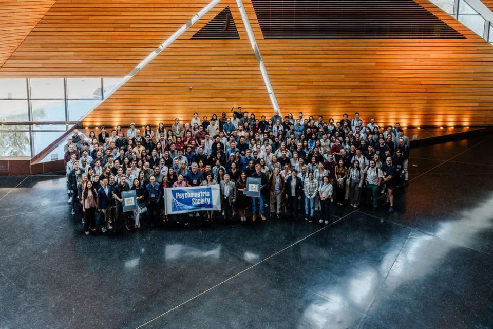 Photo of many attendees for IMPS 2025 standing together