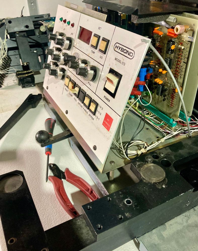 Partially disassembled wire bonder machine.