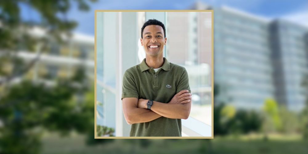 Photo of Michael Oliphant, PhD, overlayed a blurred picture of CU Anschutz. Michael is smiling and has his arms crossed. He is wearing a green polo.
