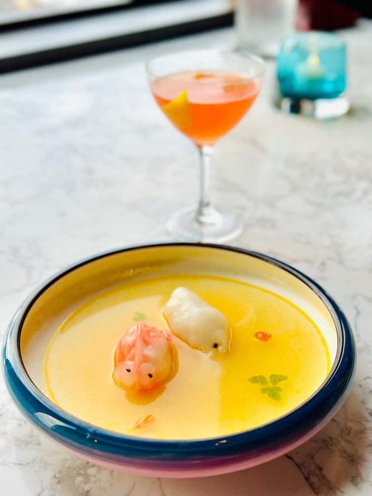 dumplings in hot and sour soup and a cocktail at empress by boon