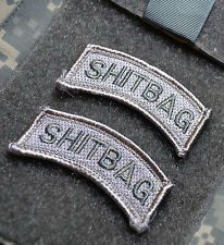 Army ACU uniform tabs that say “shitbag” on them.