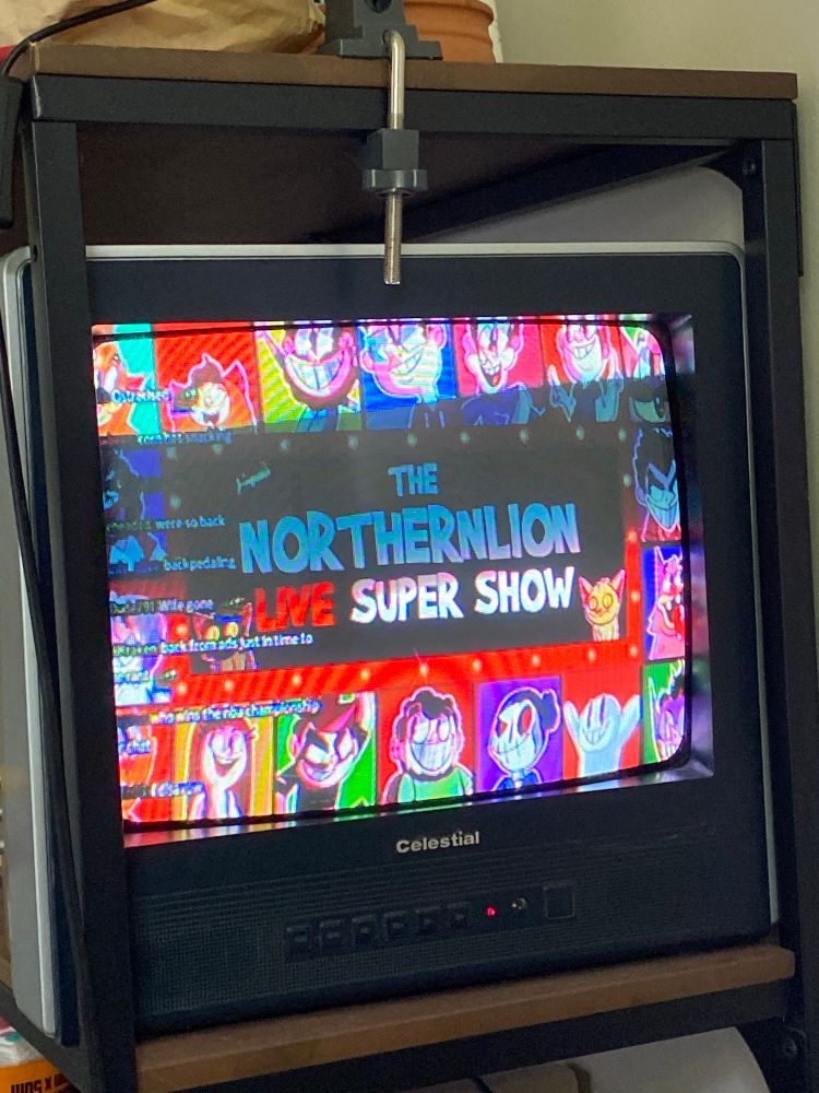 a northernlion video playing on a celestial CRT TV on a bookshelf