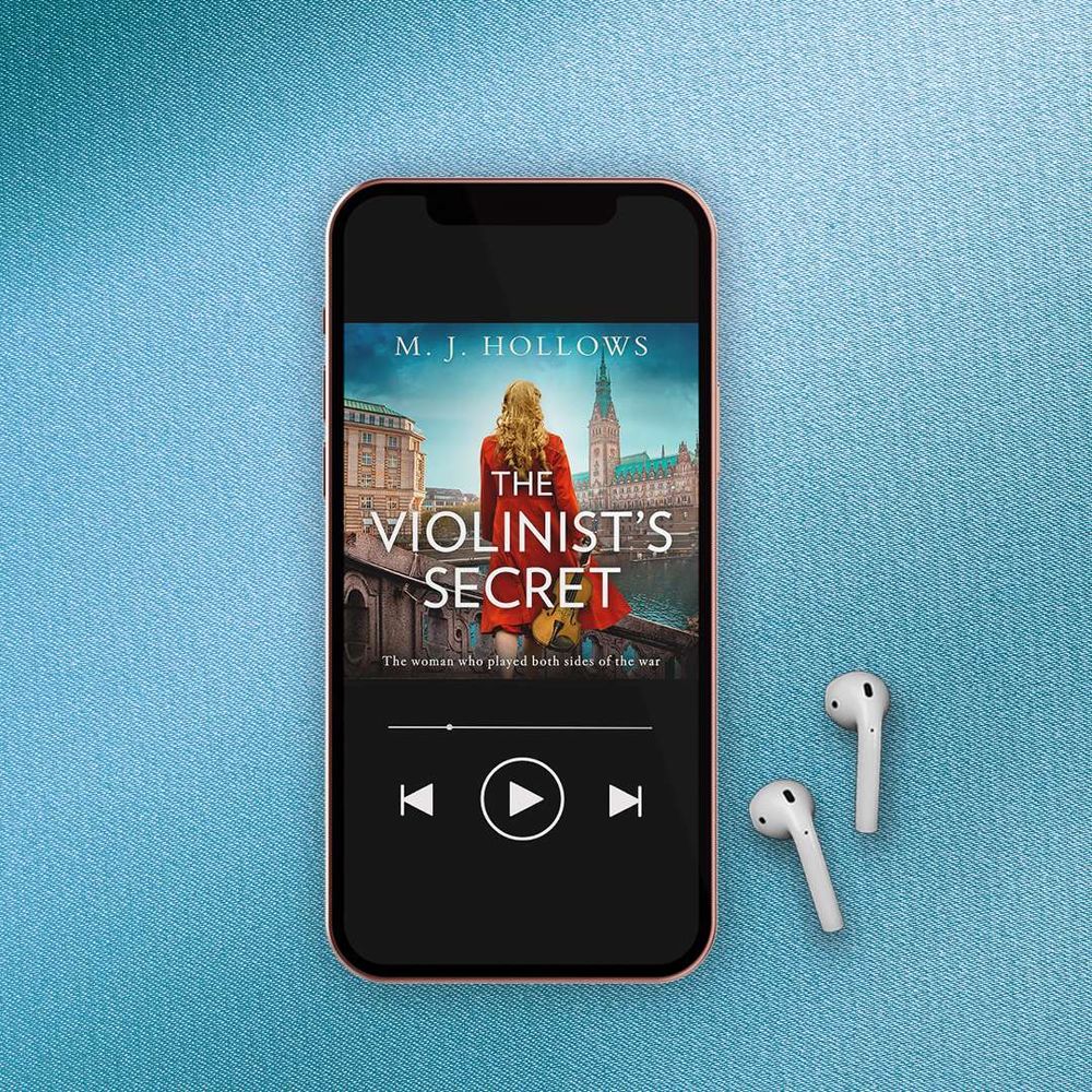 The cover of Violinist's Secret on a device. With some earpods next.
