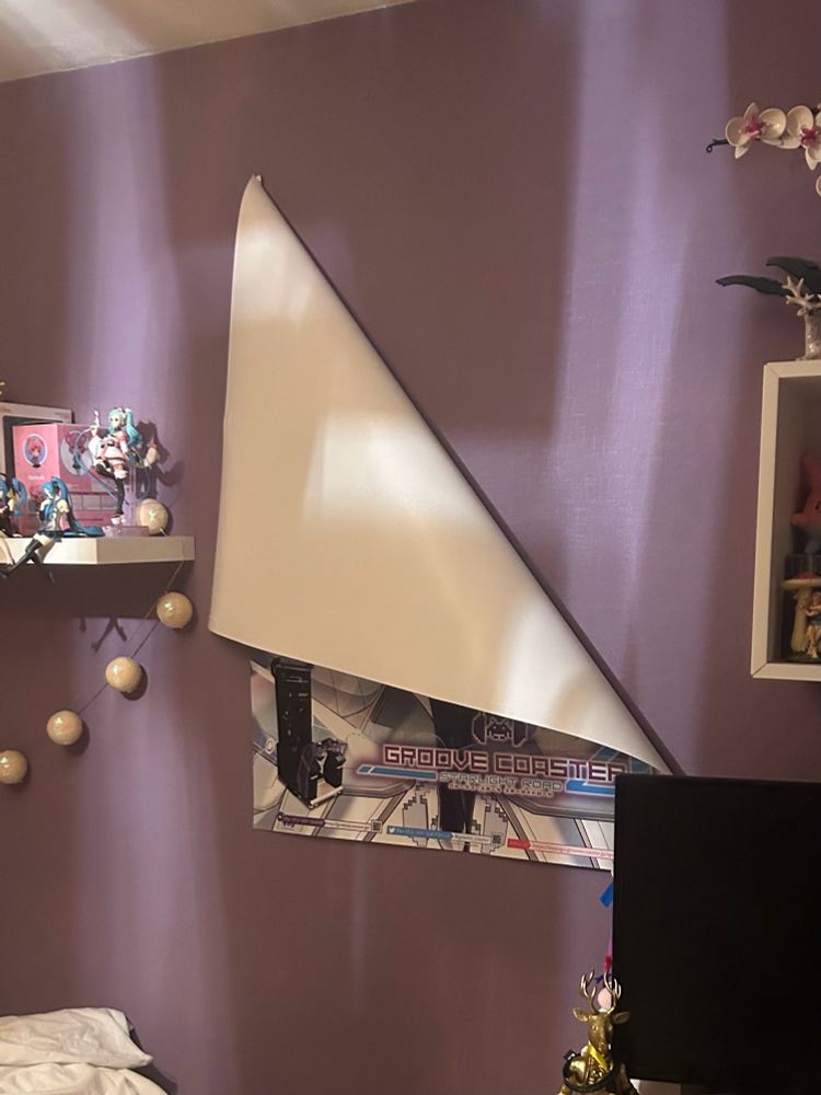 poster came off the wall, partially from the top