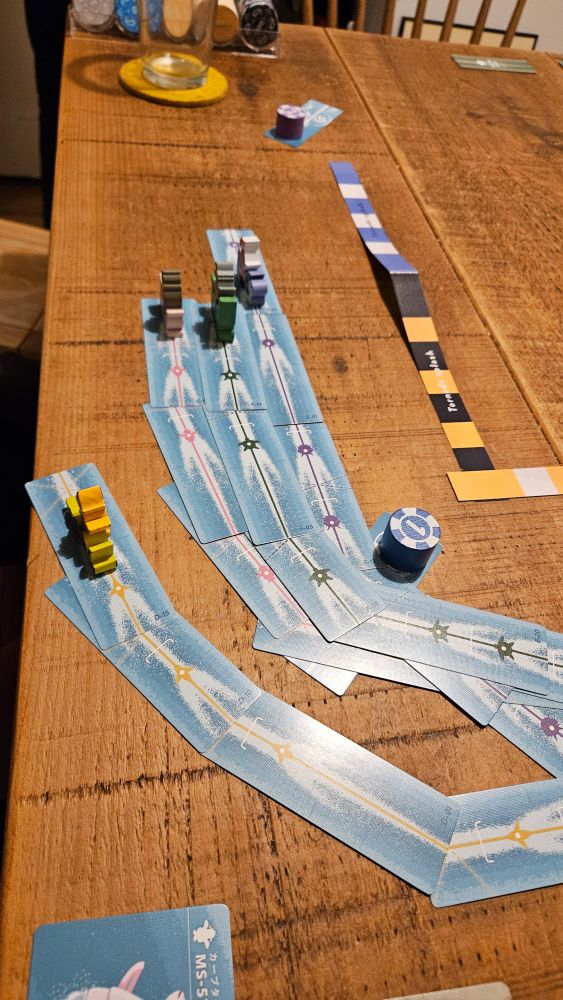 One meeple has gone wide, skirting the table edge. The others bomb down a straight