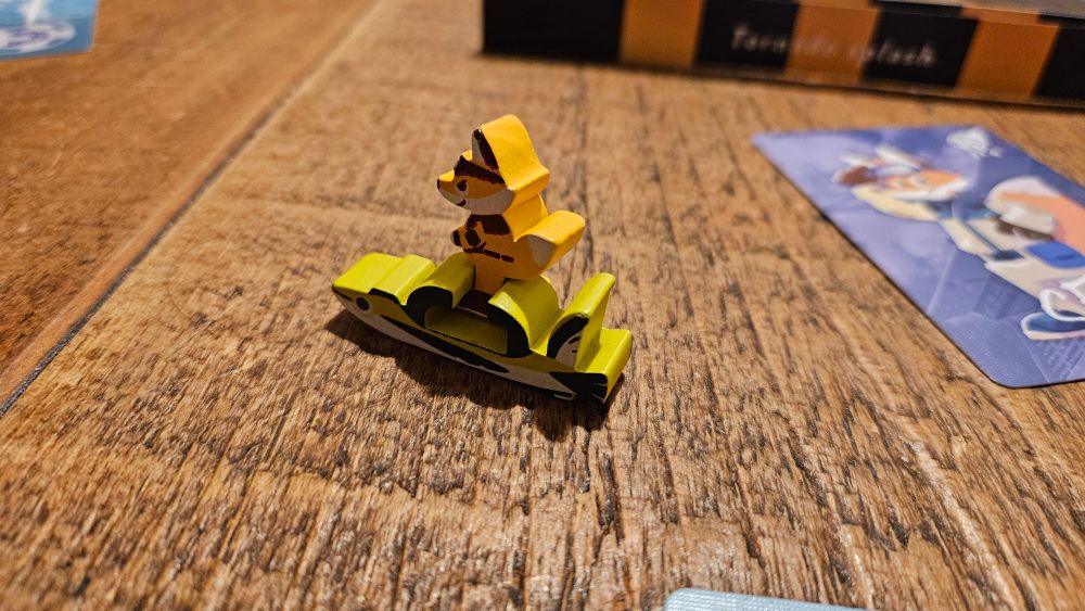 A fox meeple can be slid into a little speedboat meeple. 'Sena' boards hops on the flying fish.