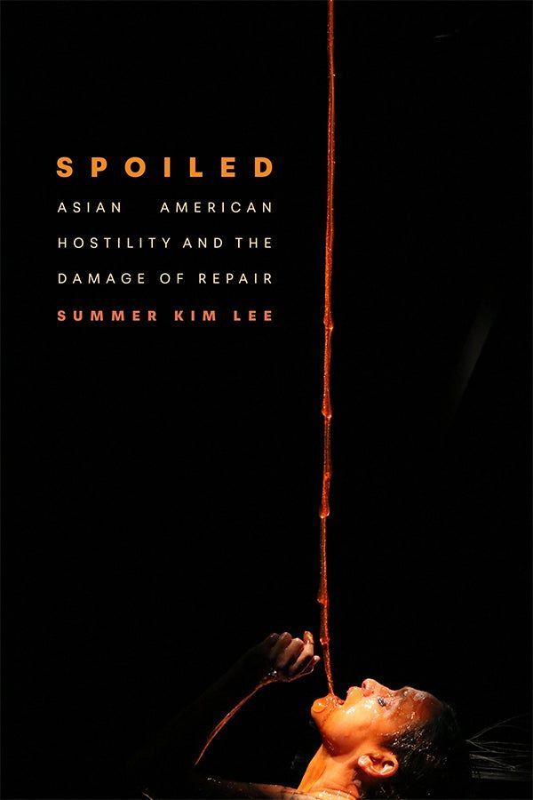 Cover of Spoiled: Asian American Hostility and the Damage of Repair by Summer Kim Lee. The title and author’s name appear in bold orange and white text against a black background. On the right side of the cover, a dramatic photograph shows a woman with her head tilted back. A long stream of honey pours into the woman's open mouth from above. Intense lighting highlights the woman's features.
