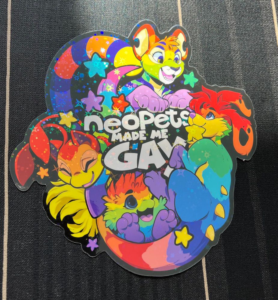 Sticker by AyceeArt that says “Neopets made me gay” surrounded by four rainbow neopets 