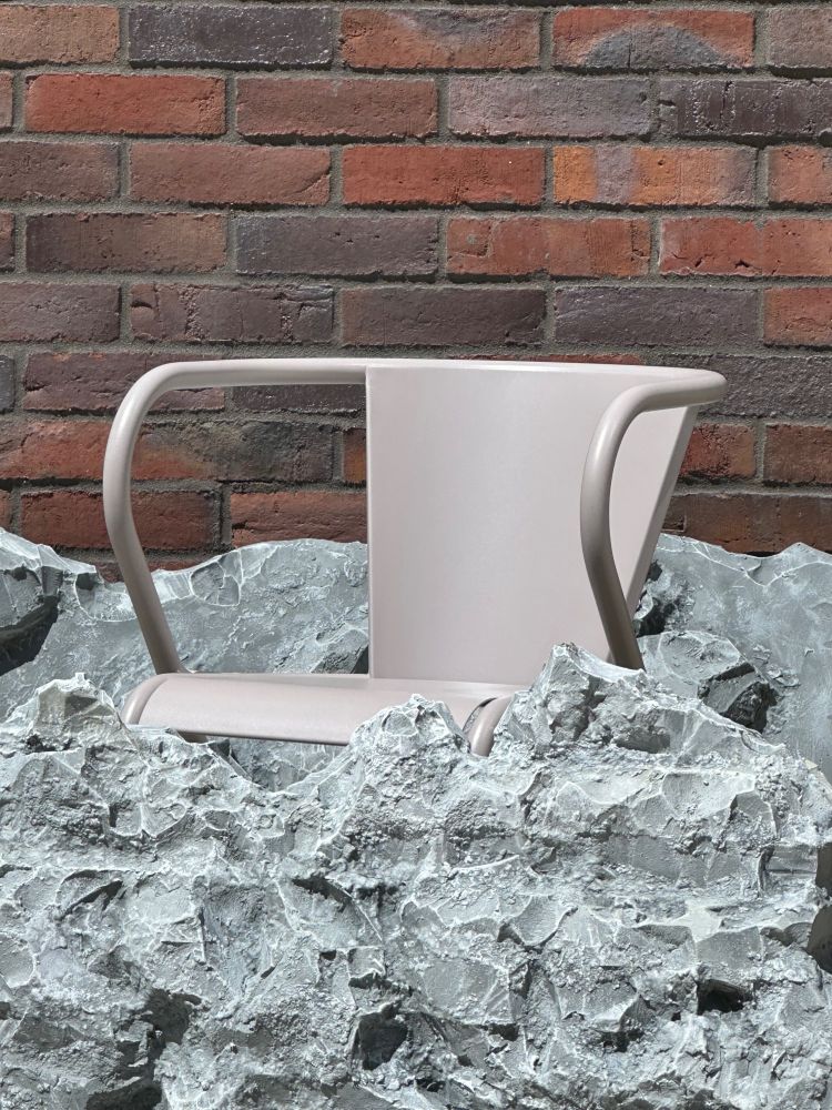 Photograph of a chair among miniature mountains