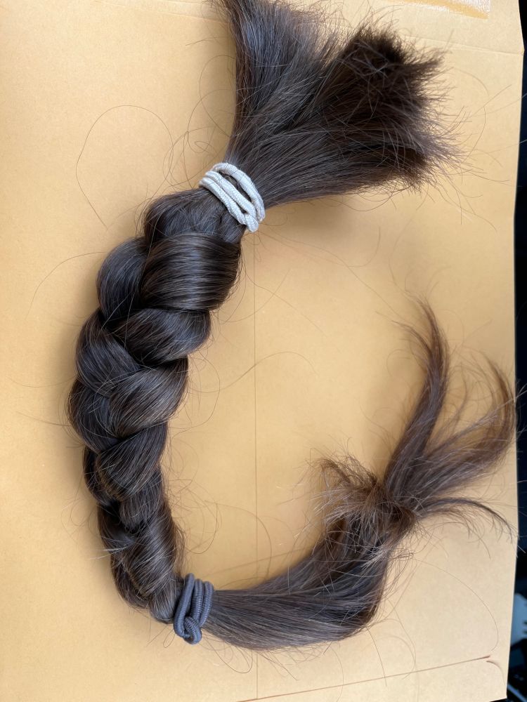 A length of braided hair that has been tied off and cut. 