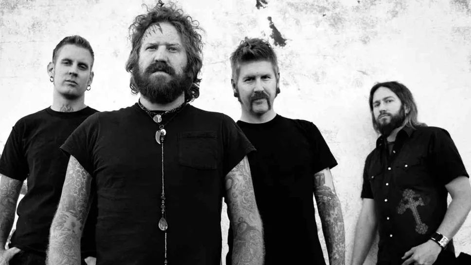 Mastodon, pictured in 2011.

From left to right

Brann Dailor (drummer/vocalist, tall thin guy with slicked back hair and stretched ears, looks like he screeches in a tight pants metal band with merch that says some dopey shit like “FUCK YOU SLUT I HOPE YOU CHOKE” in large font [thankfully Brann is very nice and has a nice singing voice])

Brent Hinds (guitarist/vocalist, broad chested white guy with arms full of tattoos, a tight black shirt, shaggy hair and facial hair, and a Polynesian face tattoo, Peak Male Performance. The Platonic ideal of a heavy metal guy, despite once famously declaring that he hated heavy metal, didn’t want to play in a “heavy metal band,” and that having to share bills with Disturbed was gay [to be fair, David Draiman ended up being a monster]. Probably got his physique from drinking a ton of beer and smoking a ton of pot. Dudes rock.)

Bill Kelliher (guitarist, white guy with a handlebar mustache, stretched ears, and lesbian fauxhawk hair. Looks like he used to dress up as James Hetfield for career day in high school, but in a cool way. Also has lots of tattoos. The one closest to smiling)

Troy Sanders (bassist/vocalist, white guy with long dark hair and neatly maintained facial hair that ends in a long but respectable pointed beard. Pretty but not in an androgynous way. Wearing a black short sleeved button up with a stylized cross on it. The only one with no tattoos)