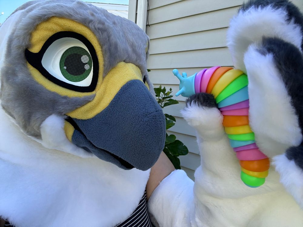 Sam looking at the slug toy while holding it in one wing/hand up to her eyes
