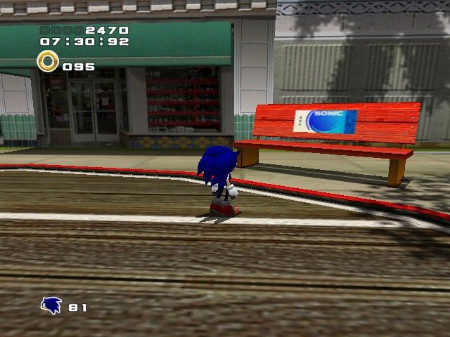 sonic adventure 2 screenshot of sonic in the first level (city escape) in a city looking at a red bench that just has an advertisement with the text "sonic"