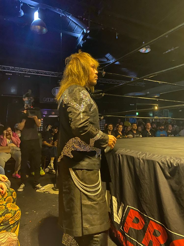Tetsuya Naito standing by a ring at RevPro in Sheffield during his entrance