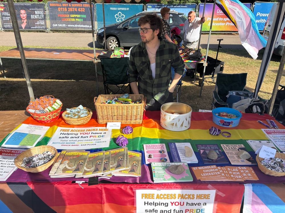 A close up of the St nicks stall with cake, flyers, zines, badges, etc available 