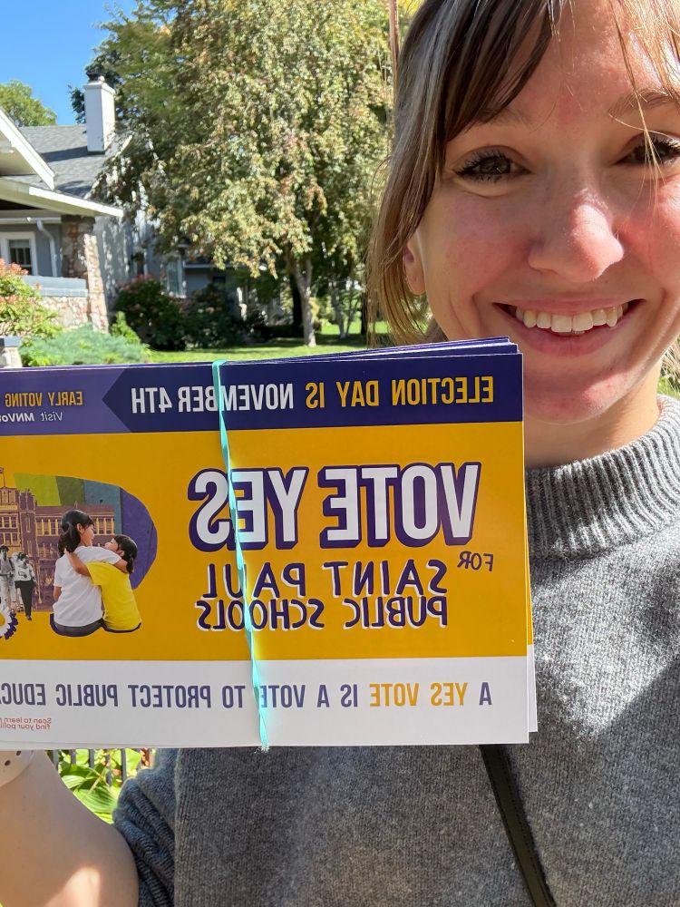 Selfie holding a “vote yes for Saint Paul public schools” flyer 