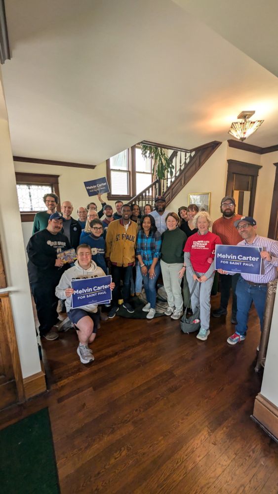 Melvin Carter and a large group of supporters pose for a photo.