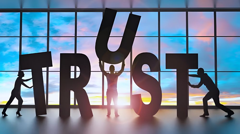 People carrying huge letters that spell the word 'trust'